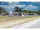 A single-story home featuring a fenced yard, landscaping, and white exterior at 601 Berkshire Rd, Daytona Beach, FL 32114