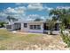 Charming single-story home with white exterior and red trim, surrounded by a well-manicured lawn at 601 Berkshire Rd, Daytona Beach, FL 32114