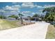 A wide view of home with a concrete driveway and chain-link fence surrounding the property at 601 Berkshire Rd, Daytona Beach, FL 32114