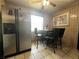 Cozy eat-in kitchen featuring stainless steel refrigerator and breakfast nook at 601 Berkshire Rd, Daytona Beach, FL 32114