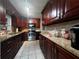 Well-lit kitchen featuring dark wood cabinetry, granite countertops, and stainless steel appliances at 601 Berkshire Rd, Daytona Beach, FL 32114