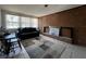 Living room with faux brick fireplace, large windows, and tile flooring at 601 Berkshire Rd, Daytona Beach, FL 32114