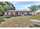 Spacious backyard showcasing deck, siding and mature landscaping for outdoor enjoyment at 663 E Lansdowne Ave, Orange City, FL 32763