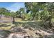 Well manicured backyard with deck, mature trees and fenced perimeter at 663 E Lansdowne Ave, Orange City, FL 32763