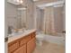 Cozy bathroom featuring a seashell themed shower curtain over a tub, vanity with wood cabinets at 663 E Lansdowne Ave, Orange City, FL 32763