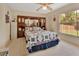 Comfortable bedroom with a decorative headboard, ceiling fan, and window at 663 E Lansdowne Ave, Orange City, FL 32763