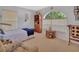 Bedroom featuring arch window with blind, upholstered furniture, bookshelf, and accent table at 663 E Lansdowne Ave, Orange City, FL 32763