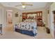 Comfortable bedroom with a decorative headboard, ceiling fan, and carpet floors at 663 E Lansdowne Ave, Orange City, FL 32763