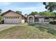 Charming single-story home featuring a two-car garage and well-maintained front yard at 663 E Lansdowne Ave, Orange City, FL 32763