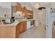 Cozy kitchen featuring light wood cabinets, white appliances, and tile flooring at 663 E Lansdowne Ave, Orange City, FL 32763