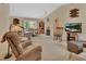 Comfortable living room with vaulted ceilings and a partial view into the dining area at 663 E Lansdowne Ave, Orange City, FL 32763