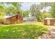 Expansive backyard featuring a brick home, pool with enclosure, and a separate brick outbuilding at 712 S Timberlane Dr, New Smyrna Beach, FL 32168