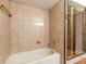 Bathroom featuring a bathtub and tiled walls at 712 S Timberlane Dr, New Smyrna Beach, FL 32168