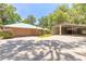 Exterior view of a well-maintained home with a garage and a carport at 712 S Timberlane Dr, New Smyrna Beach, FL 32168