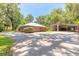 Side view of property, complete with a detached garage and large metal storage building at 712 S Timberlane Dr, New Smyrna Beach, FL 32168