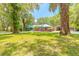 Expansive front yard with well-maintained lawn and mature trees lead to this lovely home at 712 S Timberlane Dr, New Smyrna Beach, FL 32168
