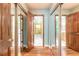 Hallway with wood floors and mirrored closet doors at 712 S Timberlane Dr, New Smyrna Beach, FL 32168