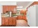 Traditional kitchen featuring custom wood cabinetry, granite countertops, and brick flooring at 712 S Timberlane Dr, New Smyrna Beach, FL 32168