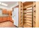 Well-organized kitchen with a pantry, a refrigerator, and wooden cabinets at 712 S Timberlane Dr, New Smyrna Beach, FL 32168
