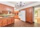 Spacious kitchen with brick floors, wood cabinets, modern appliances, and a kitchen island at 712 S Timberlane Dr, New Smyrna Beach, FL 32168