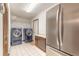 Laundry room with stainless steel refrigerator, washer and dryer, and a storage closet at 712 S Timberlane Dr, New Smyrna Beach, FL 32168