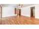 Bright living room with hardwood floors, ceiling fan, and built in bookshelves at 712 S Timberlane Dr, New Smyrna Beach, FL 32168