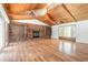 Spacious living room with a brick fireplace, vaulted wood ceilings, and gleaming hardwood floors at 712 S Timberlane Dr, New Smyrna Beach, FL 32168