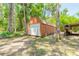Large, rustic outbuilding with a roll-up door, side door, and space for wood storage at 712 S Timberlane Dr, New Smyrna Beach, FL 32168