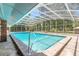 A screened-in pool and patio with views of the backyard and landscaping at 712 S Timberlane Dr, New Smyrna Beach, FL 32168