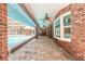 A screened-in, brick paved pool area featuring ceiling fans and access to the main house at 712 S Timberlane Dr, New Smyrna Beach, FL 32168