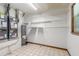 Utility room featuring tiled floors, storage shelves, water heater, and a furnace at 712 S Timberlane Dr, New Smyrna Beach, FL 32168