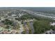 Expansive aerial shot showcasing a residential community with a mix of homes, waterways, and natural wooded areas at 723 Oakwater Ln, Port Orange, FL 32128