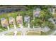Aerial view of a residential neighborhood near a road featuring houses with a pond in the back at 723 Oakwater Ln, Port Orange, FL 32128