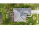 Top-down view of a well-maintained home with a screened-in patio, pristine lawn, and mature landscaping at 723 Oakwater Ln, Port Orange, FL 32128