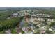An aerial view of a residential community featuring single-Gathering homes and a serene pond. Arrow indicates the subject property at 723 Oakwater Ln, Port Orange, FL 32128