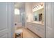 Bright bathroom featuring double vanity, tile floors, and a glass-enclosed shower at 723 Oakwater Ln, Port Orange, FL 32128