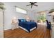 Comfortable bedroom with a queen bed, ceiling fan, and sliding glass door to the lanai at 723 Oakwater Ln, Port Orange, FL 32128