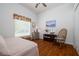 Comfortable bedroom with wood floors, a rocking chair and bright window at 723 Oakwater Ln, Port Orange, FL 32128