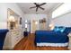 Spacious bedroom with a ceiling fan, dresser, and ample natural light at 723 Oakwater Ln, Port Orange, FL 32128