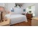 Cozy bedroom features wood floors, a plush bed, and bright, natural light from the window at 723 Oakwater Ln, Port Orange, FL 32128