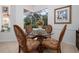 Cozy dining area with glass top table, view of screened lanai, and comfortable seating at 723 Oakwater Ln, Port Orange, FL 32128