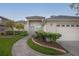 Welcoming single-story home with a well-kept lawn, garden beds, and an attached two-car garage at 723 Oakwater Ln, Port Orange, FL 32128