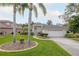 Attractive single-story home showcasing lush landscaping, mature trees, and a convenient two-car garage at 723 Oakwater Ln, Port Orange, FL 32128