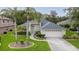 Inviting single-story home featuring a manicured lawn, mature palm trees, and an attached two-car garage at 723 Oakwater Ln, Port Orange, FL 32128