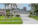 Charming single-story home featuring a well-maintained lawn, mature trees, and an attached two-car garage at 723 Oakwater Ln, Port Orange, FL 32128