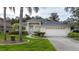 Charming home exterior featuring a well-manicured lawn, decorative landscaping, and a two-car garage at 723 Oakwater Ln, Port Orange, FL 32128