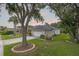 Charming single-story home featuring a well-maintained lawn, mature trees and an attached two car garage at 723 Oakwater Ln, Port Orange, FL 32128