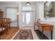 Bright foyer featuring decorative glass door, tile flooring, wood accents, and elegant decor at 723 Oakwater Ln, Port Orange, FL 32128