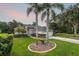 Inviting single-Gathering home featuring lush landscaping, mature palm trees, and a well-manicured lawn at 723 Oakwater Ln, Port Orange, FL 32128