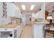 Well-lit kitchen with white cabinets, skylights, tile flooring, and a breakfast bar at 723 Oakwater Ln, Port Orange, FL 32128